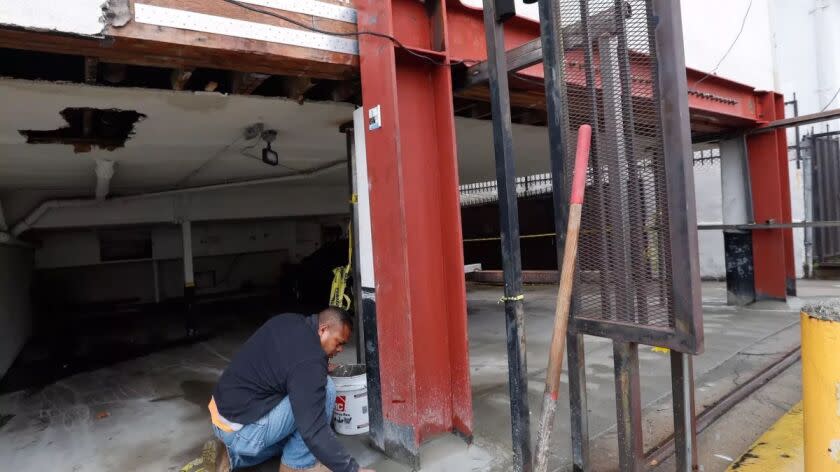 Construction worker reinforces a steel frame during a retrofit of a Hollywood apartment building.