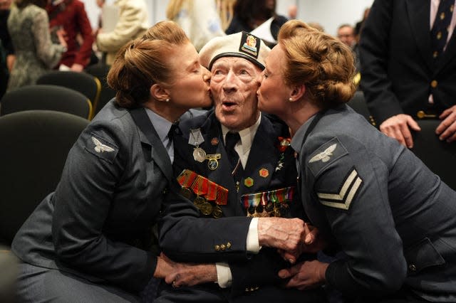 Alec Penstone receives a kiss from the D-Day Darlings at an event organised by the Spirit of Normandy Trust, in conjunction with the British Normandy Memorial, at the Union Jack Club in London 