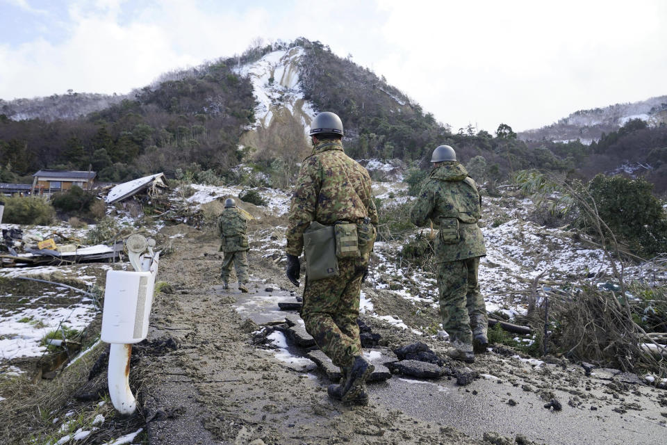 Members of Japan Self Defense Force search a landslide area in the earthquake-hit city Suzu, Ishikawa prefecture, Monday, Jan. 8, 2024. Thousands of people made homeless overnight are living in weariness and uncertainty on the western coast of Japan a week after powerful earthquakes hit the region. (Kyodo News via AP)