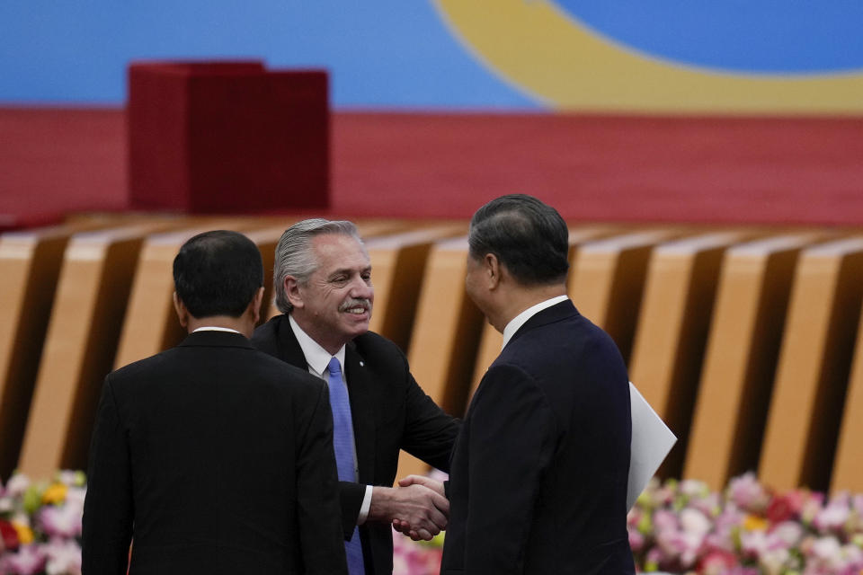 Argentina's President Alberto Fernandez, center, is greeted by his Chinese counterpart Xi Jinping, right, after delivering a speech during the Belt and Road Forum at the Great Hall of the People in Beijing, Wednesday, Oct. 18, 2023. (AP Photo/Ng Han Guan)