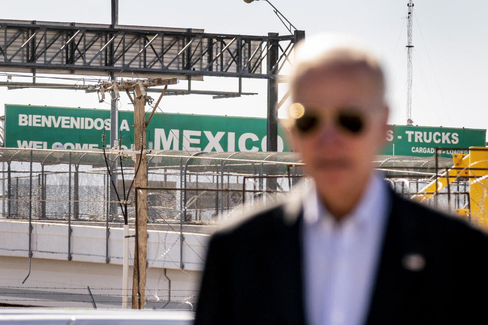 A large "Welcome to Mexico" sign hung over the Bridge of the Americas is visible as President Joe Biden talks with U.S. Customs and Border Protection officers as he tours the El Paso port of entry, a busy port of entry along the U.S.-Mexico border, in El Paso Texas, Sunday, Jan. 8, 2023. (AP Photo/Andrew Harnik)