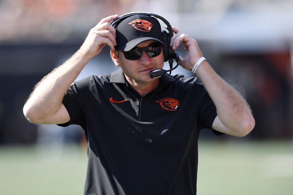 Oregon State head coach Jonathan Smith adjusts his headset during the second half of an NCAA college football game against San Diego State, Saturday, Sept. 16, 2023, in Corvallis, Ore. (AP Photo/Mark Ylen)