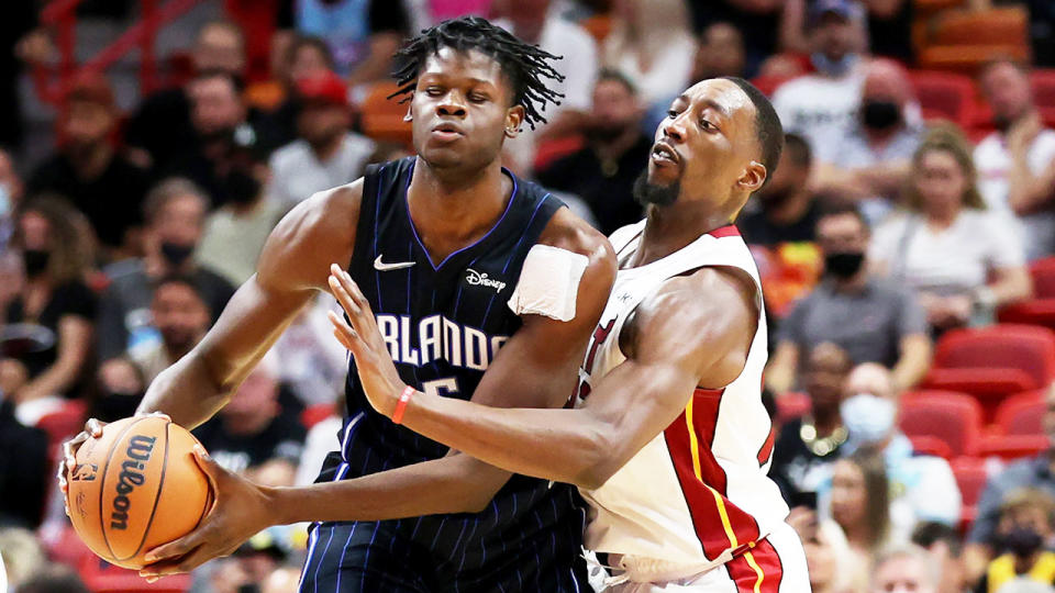 Pictured left, Mo Bamba of the Orlando Magic and Bam Adebayo of the Miami Heat vie for possession of the ball in the NBA.