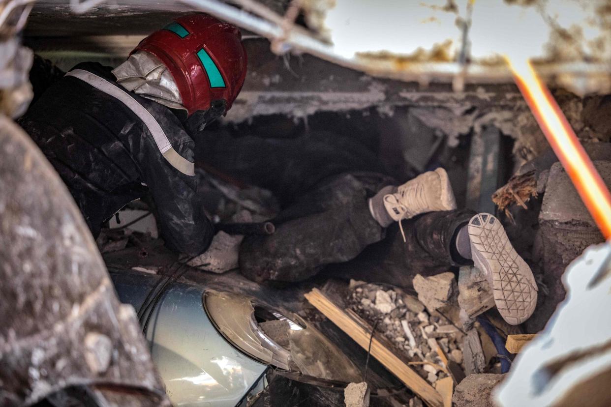 Rescuers search for survivors under the rubble of a collapsed house in Moulay Brahim (AFP via Getty Images)