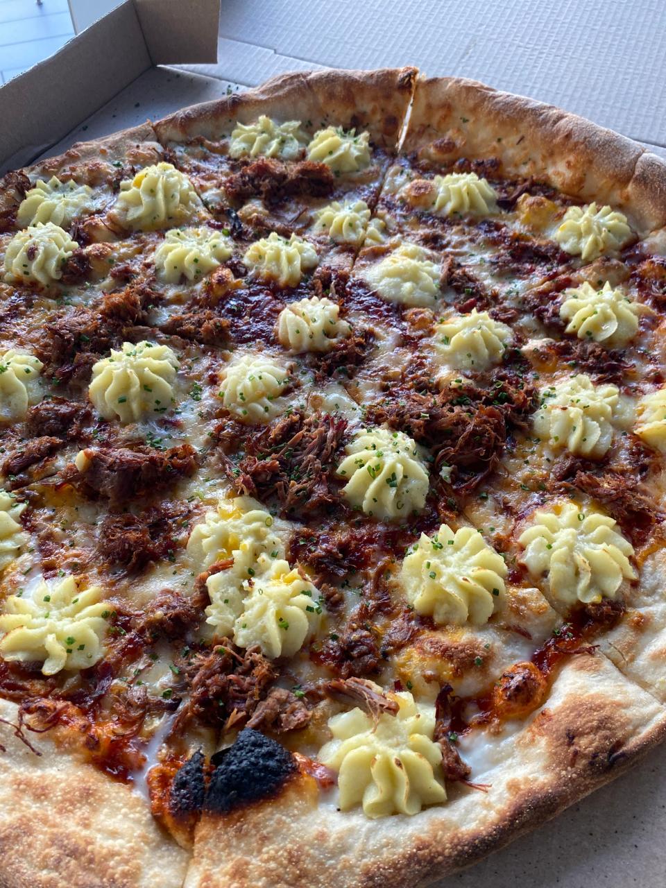 A monthly pizza special from Dado's Pizza, featuring brisket from Butcher Bar-B-Q stand and potatoes.
