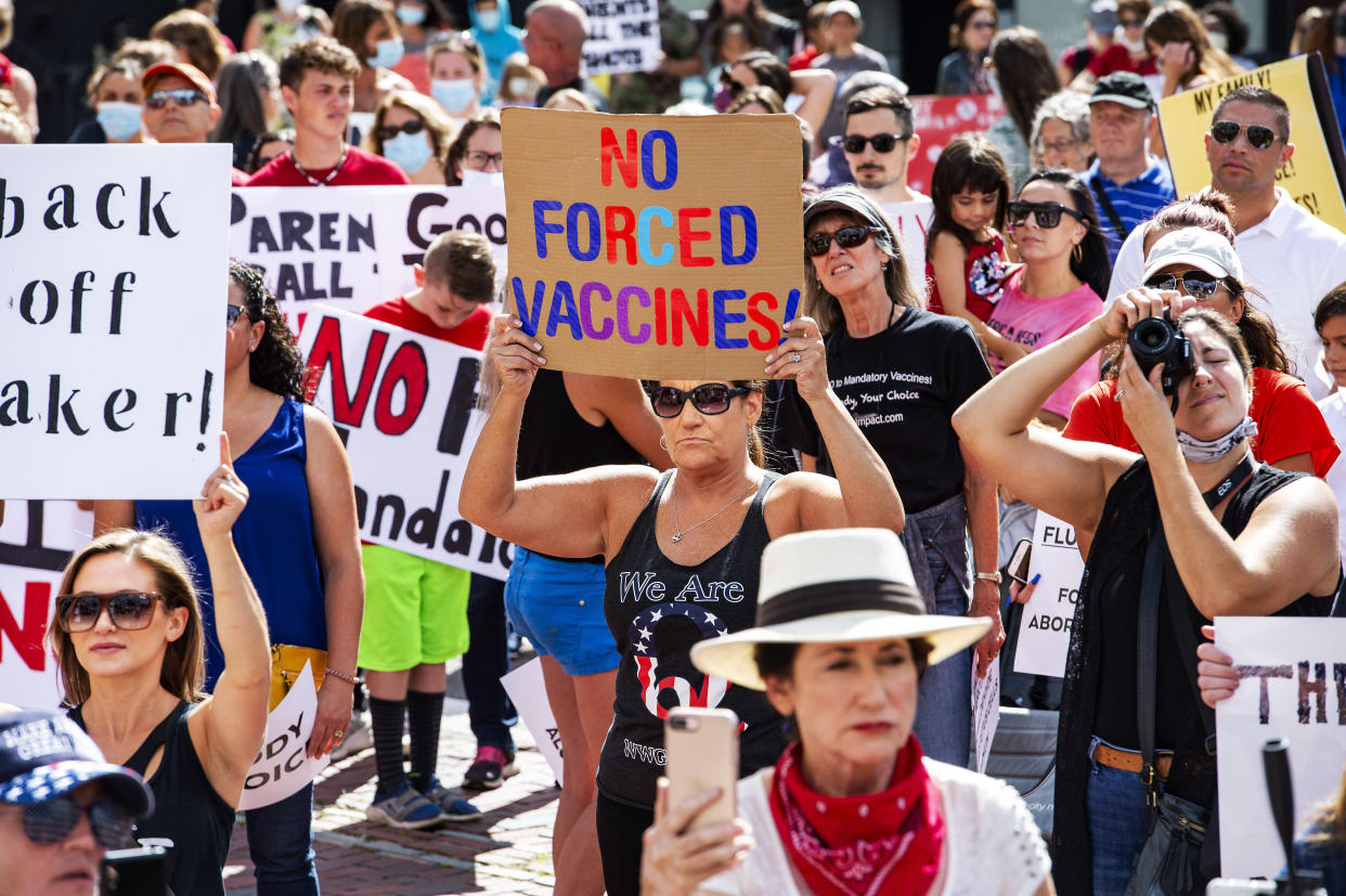 A woman wearing a QAnon shirt attends an Aug. 30 anti-vaccination protest at the Massachusetts State House in Boston. (Photo: JOSEPH PREZIOSO via Getty Images)