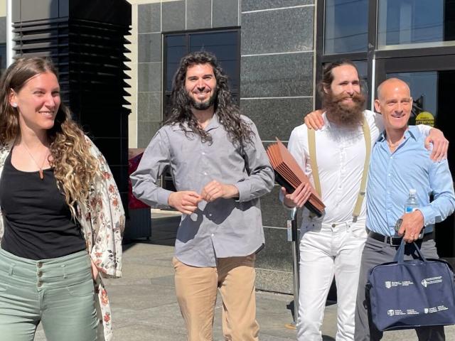 Britney Green, left, Nicholas DeAngelis, a supporter who has assisted them, and David West leave the Moncton courthouse Tuesday morning. (Shane Magee/CBC - image credit)