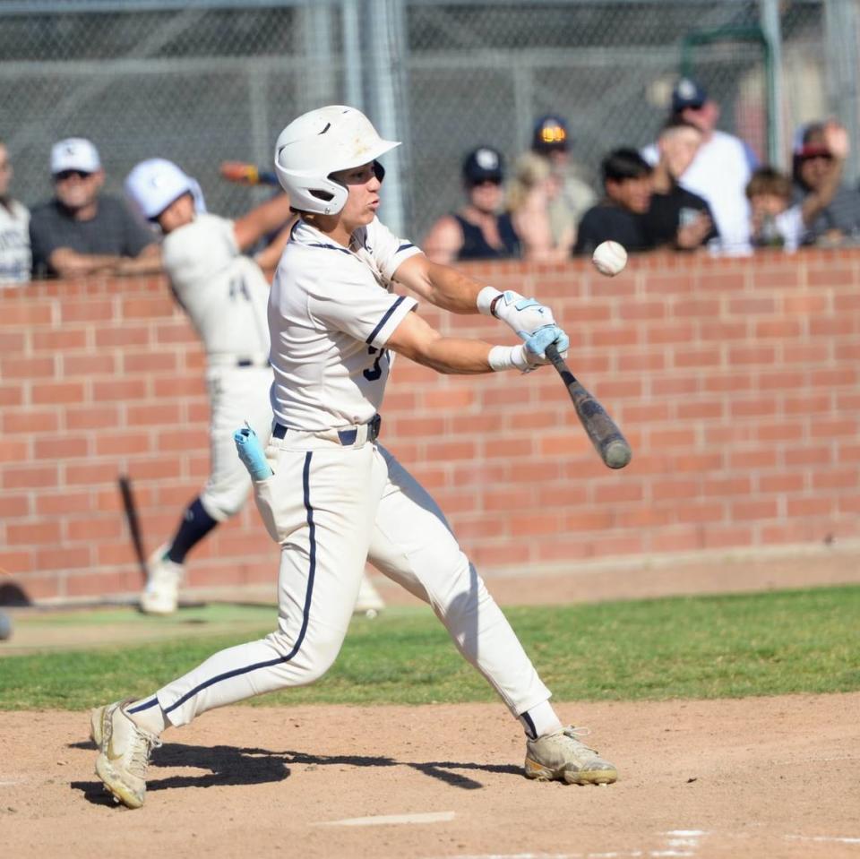 Central Catholic’s Trace Hernandez makes contact with a pitch during Game 1 of the CIF Sac-Joaquin Section D-III semifinals against Oakdale at Oakdale High School on Monday, May 13, 2024. Central Catholic took a 1-0 series lead with an 8-1 win.