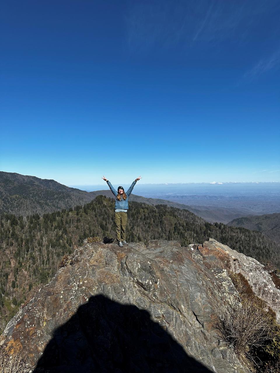 Poughkeepsie native Alexis Holzmann is photographed by a hiking partner atop the summit of a mountain during her hike of the Appalachian Trail this summer.