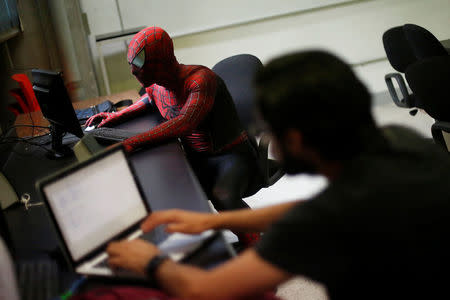 Moises Vazquez, 26, known as Spider-Moy, a computer science teaching assistant at the Faculty of Science of the National Autonomous University of Mexico (UNAM), who teaches dressed as a comic superhero Spider-Man, uses a computer during a class in Mexico City, Mexico, May 27, 2016. REUTERS/Edgard Garrido