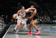 Indiana Fever guard Caitlin Clark (22) drives against New York Liberty forward Betnijah Laney-Hamilton (44) during the first half of a WNBA basketball game, Saturday, May 18, 2024, in New York. (AP Photo/Noah K. Murray)