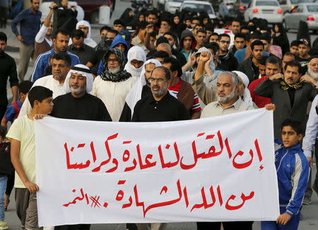 Protesters holding a banner saying "Death is normal to us and our dignity from God is martyrdom" take part in a protest against the execution of Saudi Shi'ite cleric Nimr al-Nimr by Saudi authorities, in the village of Sanabis, west of Manama, Bahrain January 2, 2016. REUTERS/Hamad I Mohammed