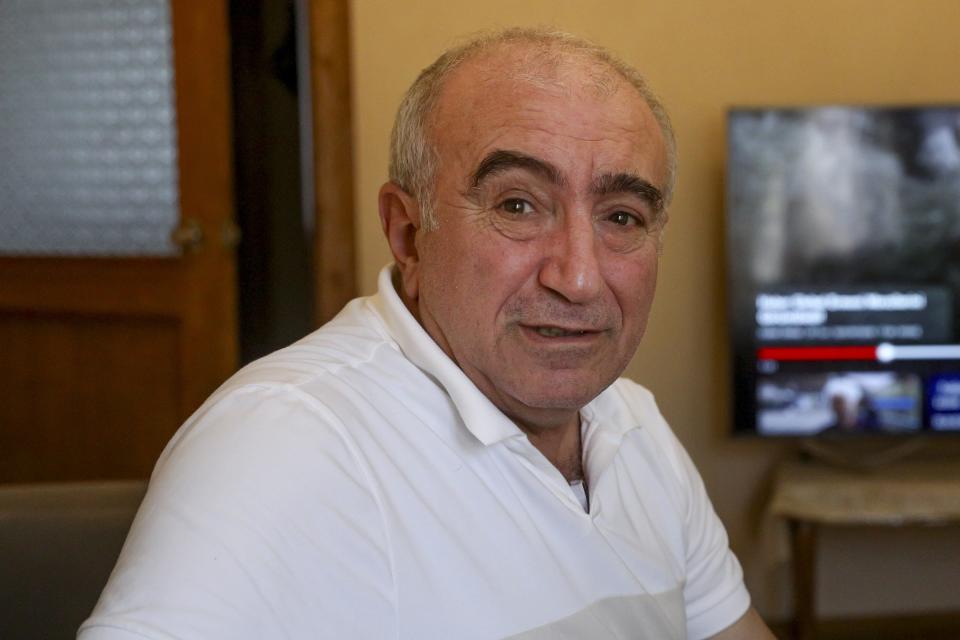 Former dentist Nazim Valiyev sits in his home in Baku, Azerbaijan, Saturday, Oct. 14, 2023. Valiyev is among the estimated 700,000 Azerbaijanis who fled or were forced out of the region amid violence that flared beginning in 1988 and then flared into an outright war that ended in 1994 with the region under the control of ethnic Armenian forces supported by Armenia. (AP Photo/Aziz Karimov)