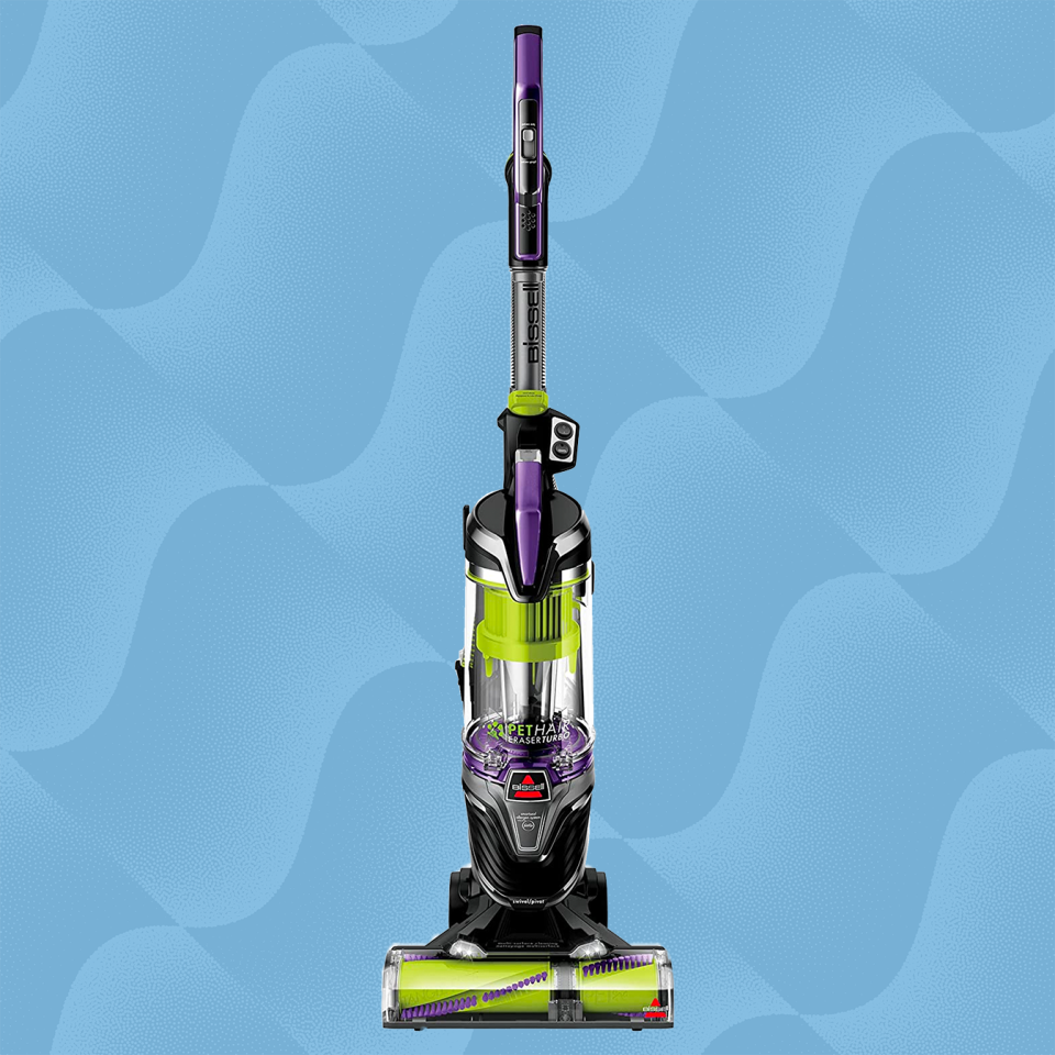 the bissell pet hair eraser vacuum against a wave blue background