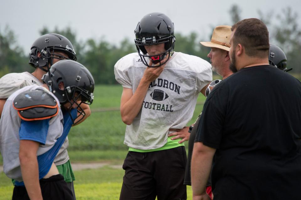 Waldron sophomore quarterback Seth Williams talks to head coach Anthony Roney during August practice.