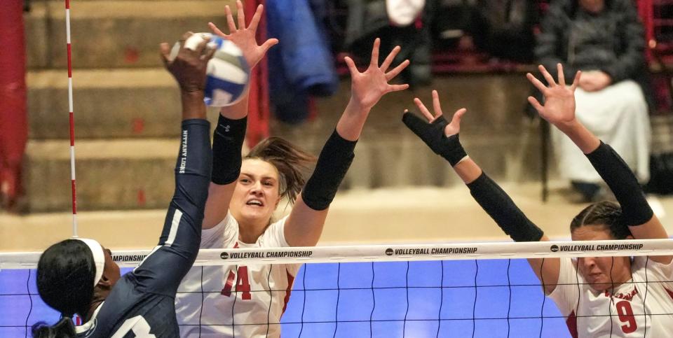 Wisconsin's Caroline Crawford (9) and Anna Smrek block a hit by Penn State's Kashauna Williams in their third-round NCAA tournament match Thursday night at the UW Field House.