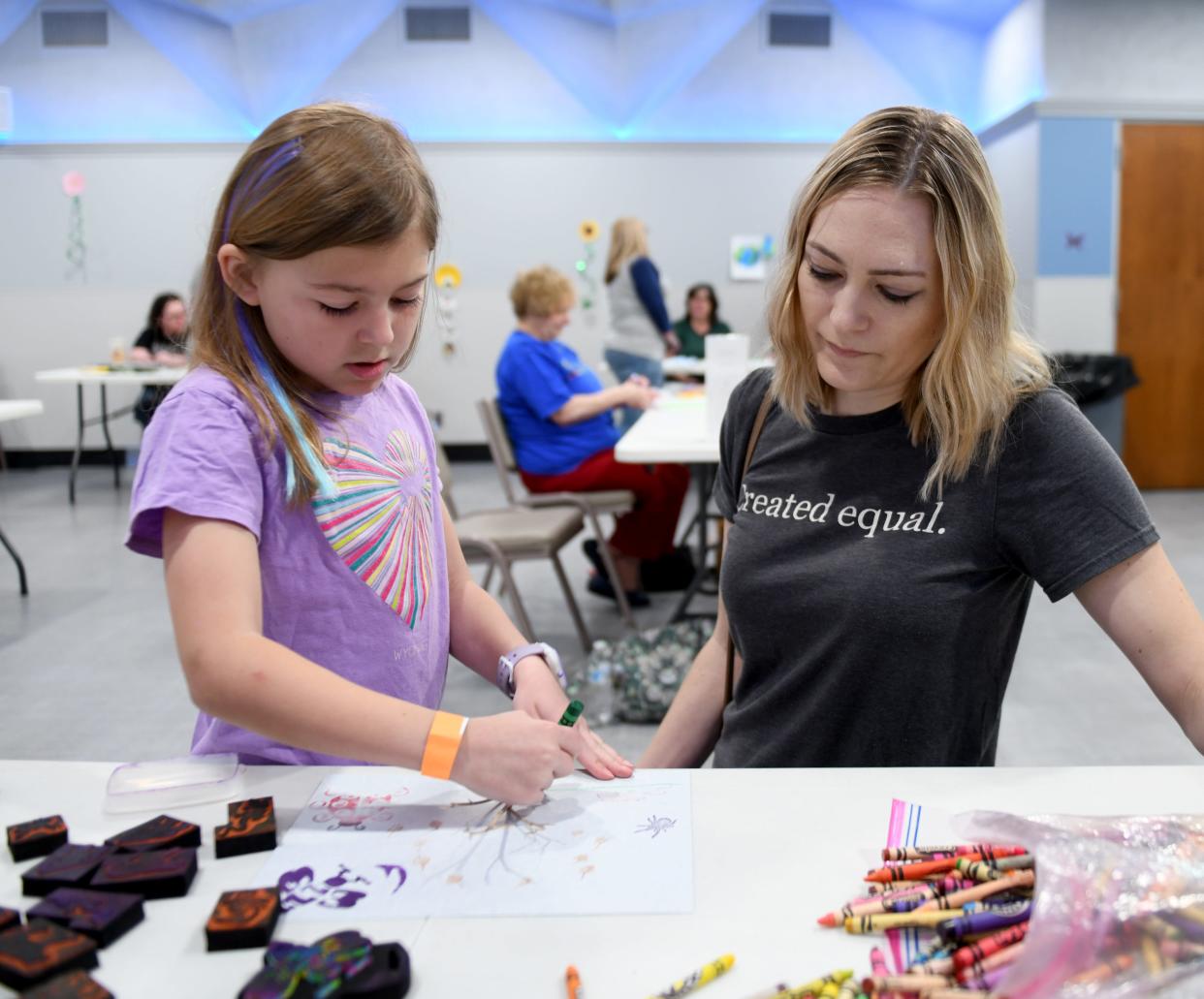 Eva Kocher, 8, and mother Jenna Kocher of Plain Township work on a nature art project during the recent Wm. McKinley Presidential Library & Museum Science Earth Day celebration.