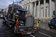 A police trade union truck drives past the Spanish parliament leading a police protest march in Madrid, Spain, Saturday, Nov. 27, 2021. Tens of thousands of Spanish police officers and their supporters rallied in Madrid on Saturday to protest against government plans to reform a controversial security law known by critics as the “gag law.” (AP Photo/Paul White)