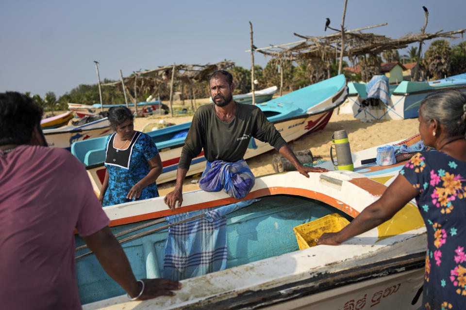 Singaram Soosaimuthu, a 45-year-old former rebel fighter, chats with friends as he returns from the sea after fishing overnight, in Mullaitivu, Sri Lanka, May 6, 2023. The former Tamil fighter lost both legs in 2009 as the nation’s generation-long civil war drew to a close and the Tamils retreated in defeat. Sri Lanka's Tamil people still live in the shadow of defeat in the civil war that tore the country apart until it ended 15 years ago. (AP Photo/Eranga Jayawardena)