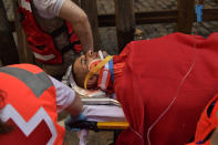 <p>A reveller lies on a stretcher after getting hurt during the third day of the running of the bulls at the San Fermin Festival in Pamplona, northern Spain, July 9, 2018. (Photo: Alvaro Barrientos/AP) </p>