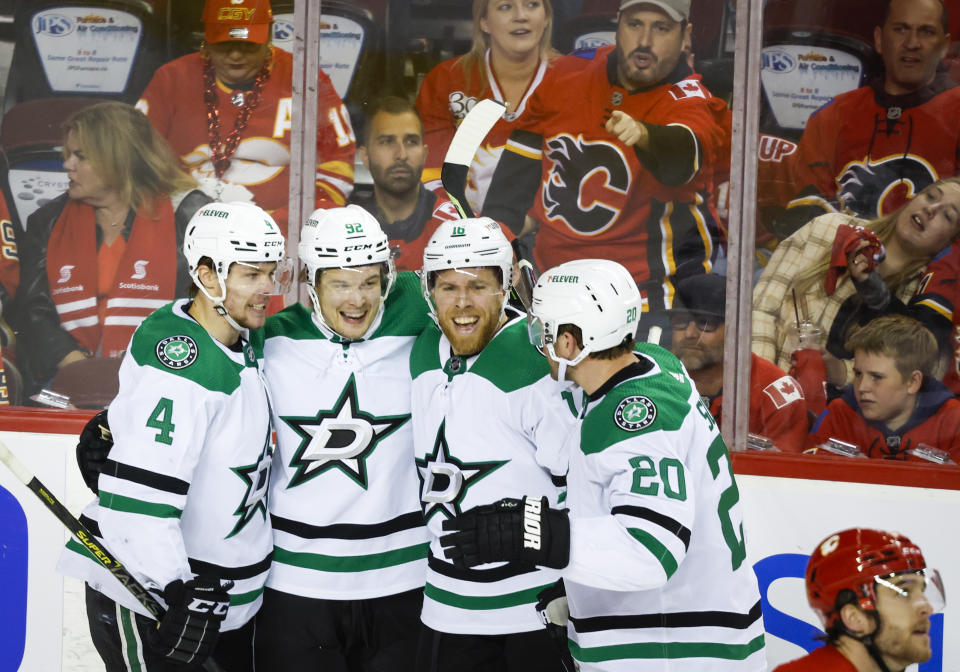 Dallas Stars forward Vladislav Namestnikov, second from left, celebrates his goal with teammates, left to right, defenseman Miro Heiskanen, forward Joe Pavelski, defenceman Ryan Suter during second period NHL playoff hockey action against the Calgary Flames in Calgary, Alberta, Sunday, May 15, 2022. (Jeff McIntosh/The Canadian Press via AP)