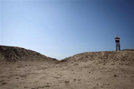 Joseph Pupello, president and CEO of Zone A New York, a non-profit organization formed after Superstorm Sandy, poses for a portrait atop a sand dyke designed to help prevent flooding in the Staten Island borough of New York, September 20, 2013. REUTERS/Carlo Allegri