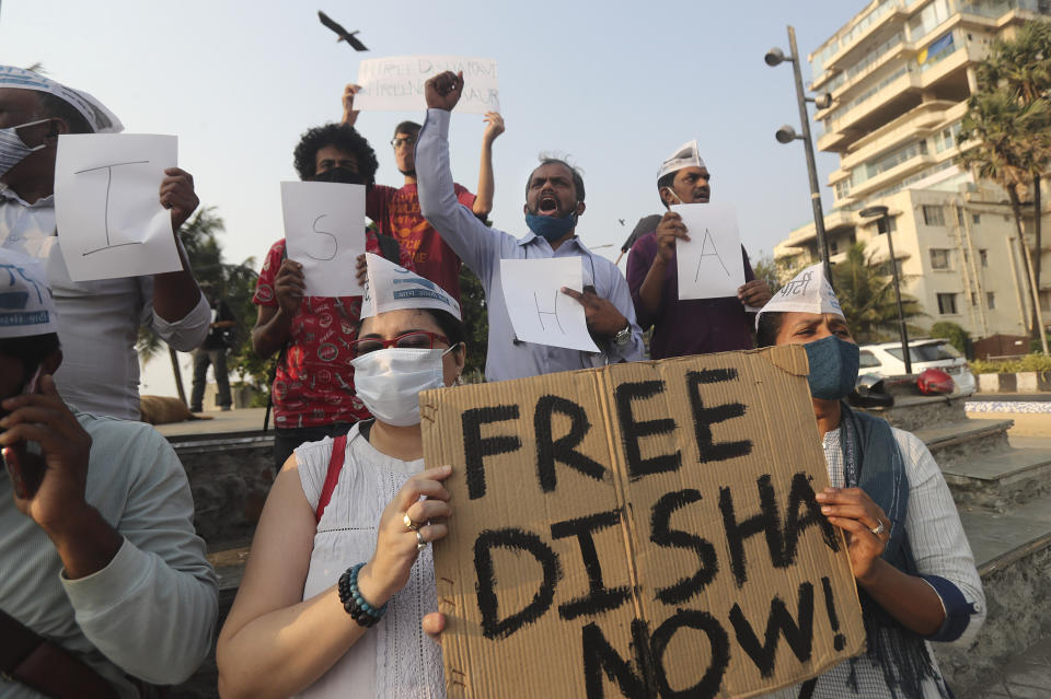 Members of Aam Aadmi Party shout slogans demanding the release of Indian climate activist Disha Ravi, during a protest in Mumbai, India, Monday, Feb. 15, 2021. The 22 years old activist was arrested Saturday for circulating a document on social media that allegedly incited protesting farmers to turn violent last month. (AP Photo/Rafiq Maqbool)