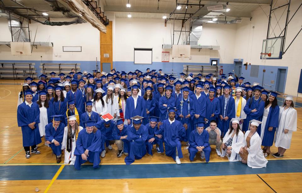 Members of the Middletown High School Class of 2022 pose for a photo inside the gymnasium at Gaudet Middle School before their graduation ceremony Saturday.