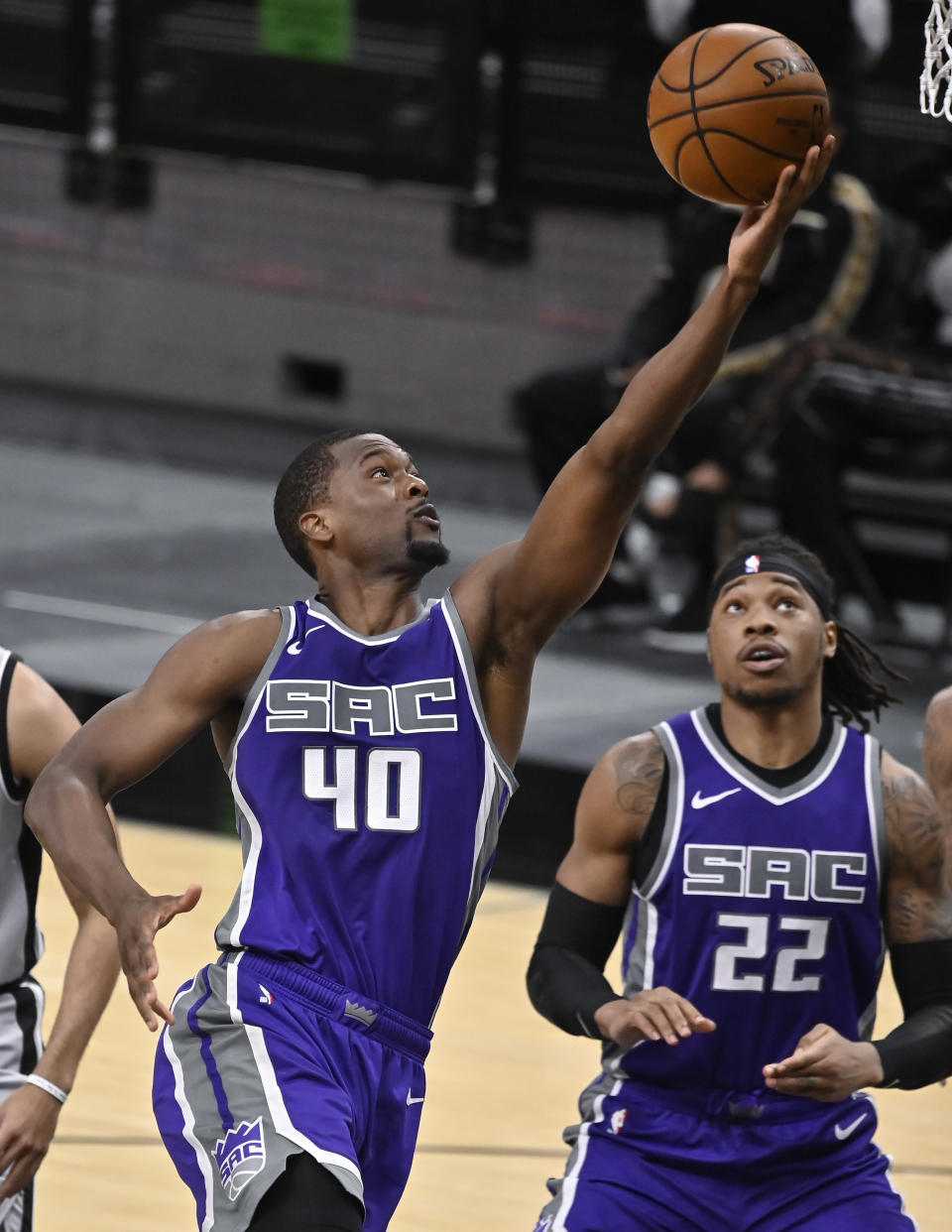 Sacramento Kings' Harrison Barnes (40) shoots as teammate Richaun Holmes looks on during the second half of an NBA basketball game against the San Antonio Spurs on Monday, March 29, 2021, in San Antonio. (AP Photo/Darren Abate)