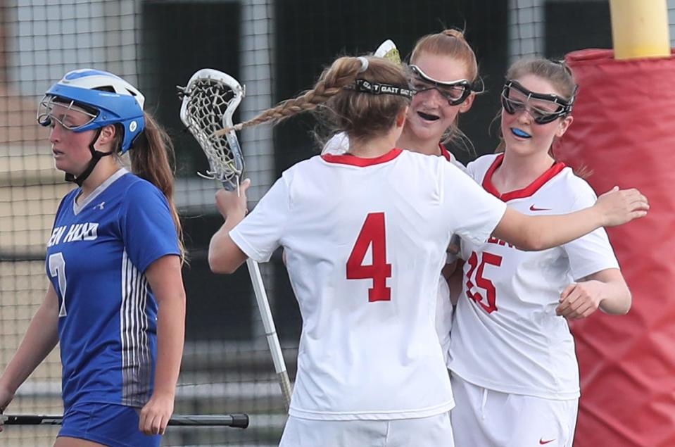 Somers' Sydney Ingraham (4) Teagan Ryan (14) and Molly Fink (15) celebrate a second half goal by Ryan against Hen Hud during girls lacrosse action at Somers High School May 11, 2023. Somers won the game 12-7.