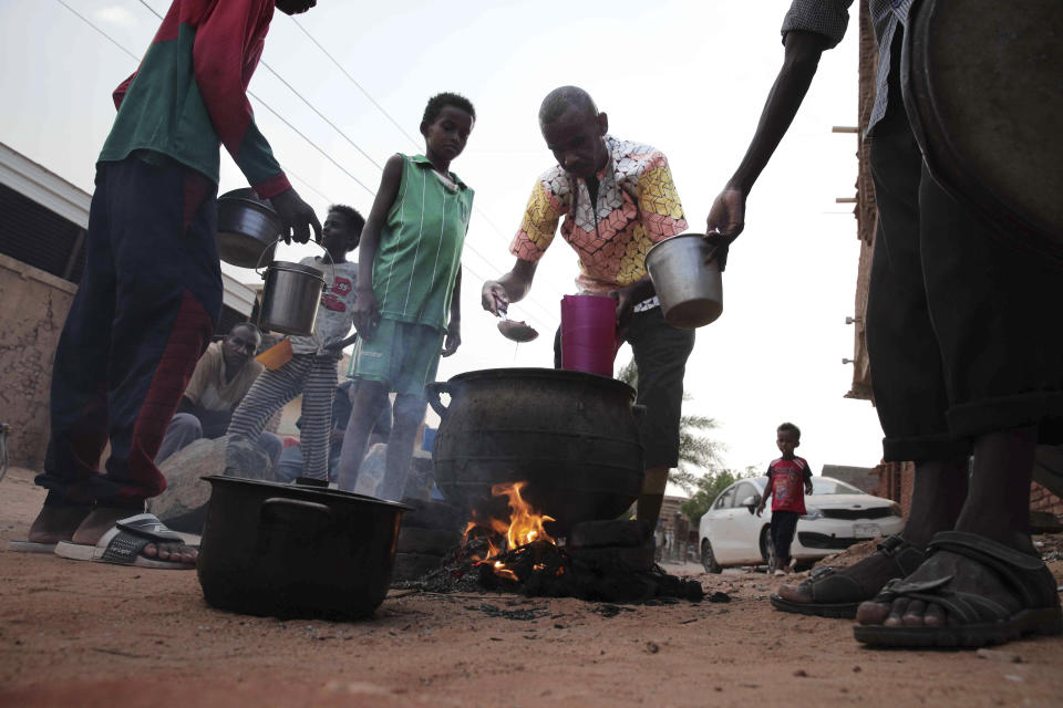 FILE - People prepare food in a Khrtoum neighborhood on June 16, 2023. Sudan has been torn by war for a year now, torn by fighting between the military and the notorious paramilitary Rapid Support Forces. (AP Photo, File)