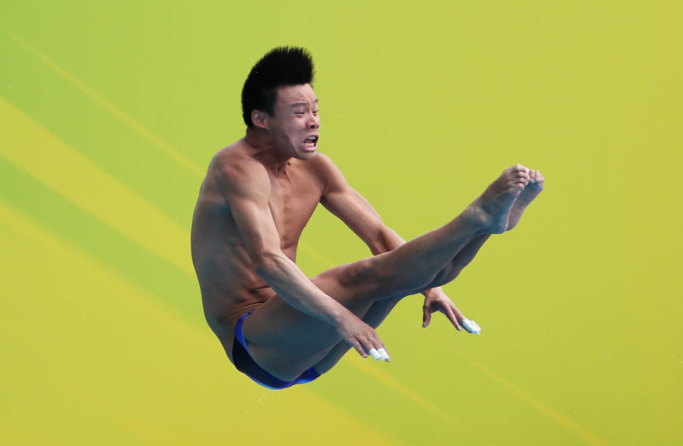 SHANGHAI, CHINA - JULY 18: He Min of the People's Republic of China competes in the Men's 1m Springboard Final during Day Three of the 14th FINA World Championships at the Oriental Sports Center on July 18, 2011 in Shanghai, China. (Photo by Lintao Zhang/Getty Images)