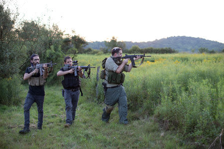 Jonathan Stern (R) and two other trainees demonstrate a takeover exercise against a hostile element as they take part in the Cherev Gidon Firearms Training Academy in Honesdale, Pennsylvania, U.S. August 5, 2018. REUTERS/Noam Moskowitz