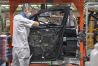 In this Feb. 17, 2020, file photo released by Xinhua News Agency, workers assemble Audi A6 L cars at a workshop of FAW-Volkswagen Automobile Co., Ltd. in Changchun, northeast China's Jilin Province. Factories that make the world's smartphones, toys and other goods are struggling to reopen after a virus outbreak idled China's economy. But even with the ruling Communist Party promising help, companies and economists say it may be months before production is back to normal. (Zhang Nan/Xinhua via AP, File)