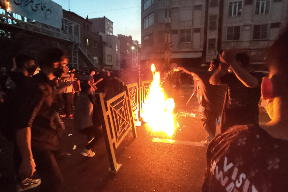 File - In this Wednesday, Sept. 21, 2022, photo taken by an individual not employed by the Associated Press and obtained by the AP outside Iran, protesters make fire and block the street during a protest over the death of a woman who was detained by the morality police, in downtown Tehran, Iran. (AP Photo, File)