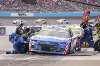 Kyle Larson makes a pit stop during a NASCAR Cup Series auto race on Sunday, Nov. 7, 2021, in Avondale, Ariz. (AP Photo/Rick Scuteri)