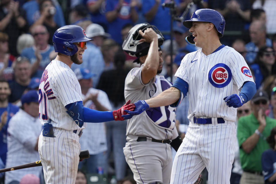 Chicago Cubs' Jared Young, right, celebrates with Miles Mastrobuoni after hitting a two-run home run during the sixth inning of a baseball game against the Colorado Rockies in Chicago, Friday, Sept. 22, 2023. (AP Photo/Nam Y. Huh)