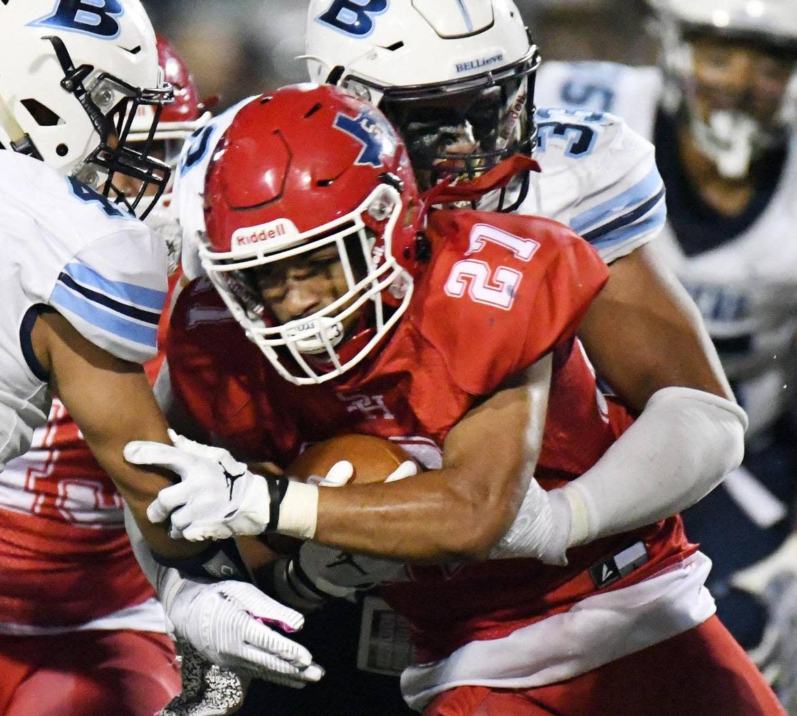 Sam Houston’s Daniel Adams, front is wrapped up by Bell’s Trey Wilson as he tries to rush for a few yards in the fourth quarter of Friday’s September 9, 2022 football game at Wilemon Field in Arlington, Texas. Bell went on to win 10-7. Special/Bob Haynes