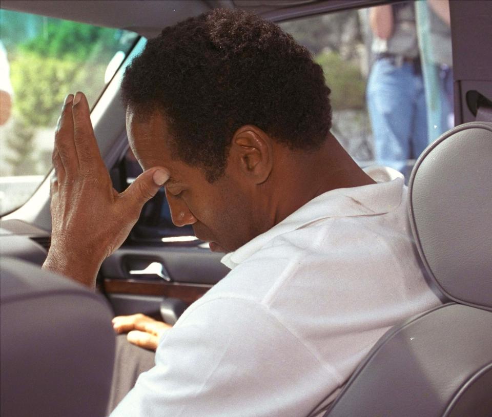 FILE - In this June 13, 1994, file photo, O.J. Simpson sits in his attorney's car after being questioned by Los Angeles police into the death of his ex-wife, Nicole Brown Simpson and her friend, Ron Goldman. Investigators quickly focused their attention on the former football great, leading to the slow-speed chase that was carried live on national television and, later, the “Trial of the Century,” which ended in Simpson’s acquittal. (AP Photo/Nick Ut, File)