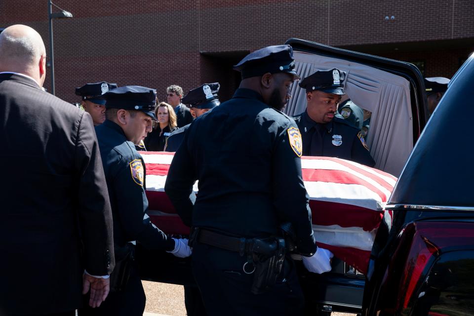 Pallbearers place the casket of Joseph McKinney, a Memphis Police Department officer who was killed during a shootout on April 12, into a hearse after carrying it out of Hope Church after McKinney’s funeral in Cordova, Tenn., on Monday, April 22, 2024.