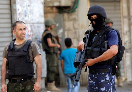 Members of Palestinian security forces take position following clashes with Palestinian youths in the old town of the West Bank city of Nablus August 23, 2016. REUTERS/Abed Omar Qusini