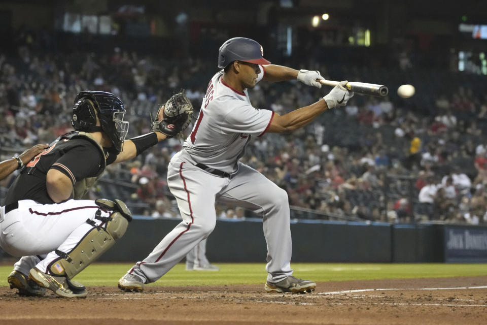 Washington Nationals Joe Ross (41) lays down a sacrifice bunt against the Arizona Diamondbacks during the second inning of a baseball game Saturday, May 15, 2021, in Phoenix. (AP Photo/Rick Scuteri)