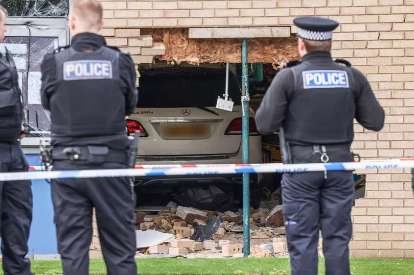 Police at the scene at Beacon Church of England Primary School in Everton this morning after a car crashed through the wall of the school