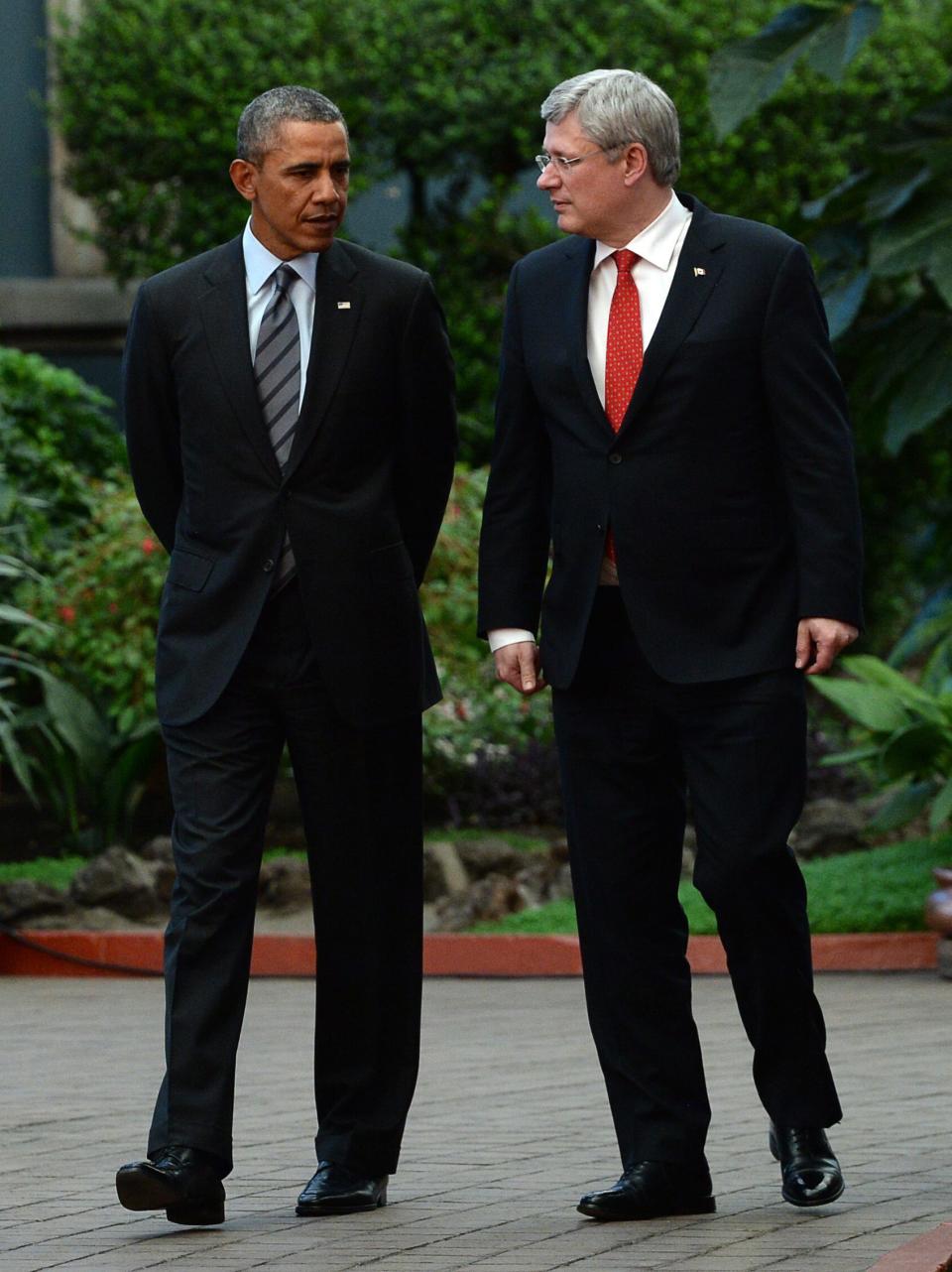 Canada's Prime Minister Stephen Harper, right, walks with President Barack Obama during the North American Leaders Summit in Toluca, Mexico, Wednesday, Feb. 19, 2014. Obama is in Toluca for a one-day summit with Mexican and Canadian leaders, meeting on issues of trade and other neighbor-to-neighbor interests, even as Congress is pushing back against some of his top cross-border agenda items. (AP Photo/The Canadian Press, Sean Kilpatrick )