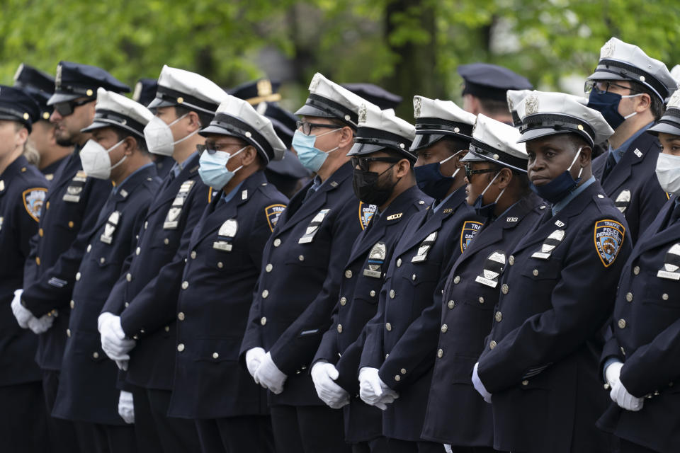 Police officers line the street as the funeral procession of New York police officer Anastasios Tsakos leaves the St. Paraskevi Greek Orthodox Shrine Church, Tuesday, May 4, 2021, in Greenlawn, N.Y. Tsakos was at the scene of an accident on the Long Island Expressway when he was struck and killed by an allegedly drunk driver a week ago. (AP Photo/Mark Lennihan)