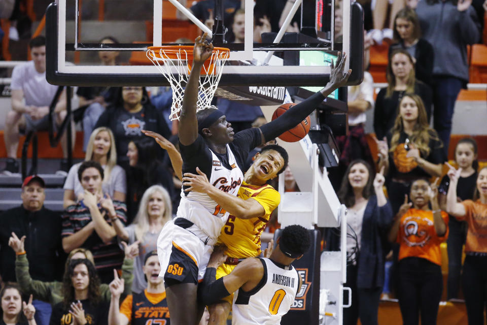 Iowa State guard Rasir Bolton, center, loses the ball between Oklahoma State forward Yor Anei, left, and guard Avery Anderson III (0) in the first half of an NCAA college basketball game in Stillwater, Okla., Saturday, Feb. 29, 2020. (AP Photo/Sue Ogrocki)