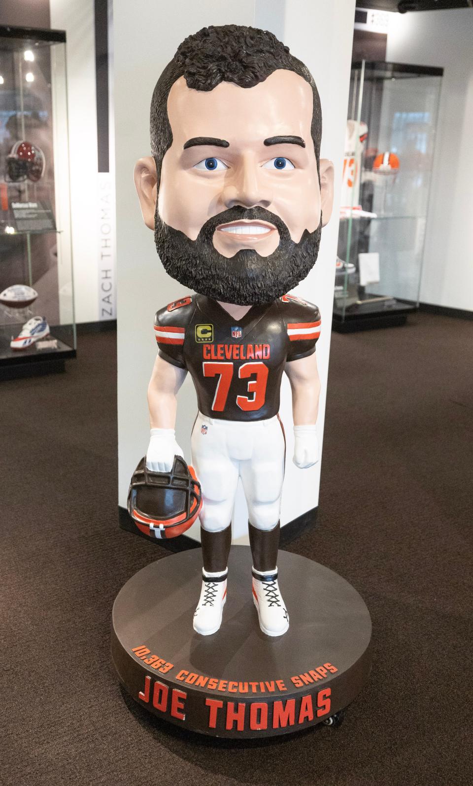 Six former Cleveland Browns players are represented in giant bobblehead figures on display in the newest Pro Football Hall of Fame exhibit, "A Legacy Unleashed."