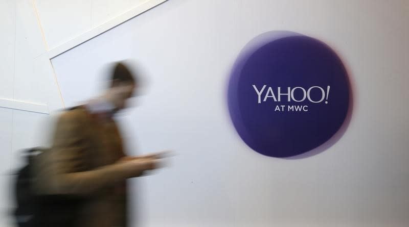 A man walks past a Yahoo logo during the Mobile World Congress in Barcelona, Spain February 24, 2016. REUTERS/Albert Gea