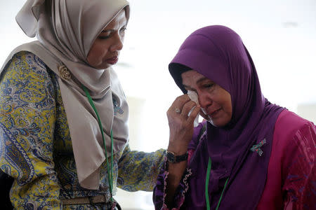 A family member cries after an MH370 closed door meeting in Putrajaya, Malaysia July 30, 2018. REUTERS/Sadiq Asyraf