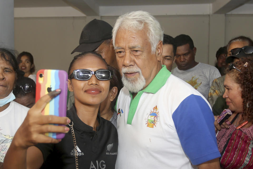 Leader of National Congress of the Reconstruction of East Timor (CNRT) party and former independence fighter Xanana Gusmao takes a selfie with a supporter in Dili, East Timor, Tuesday, May 23, 2023. The country's opposition party won Sunday's parliamentary election, meaning that Gusmao is likely to return as prime minister in Asia's youngest democracy. (AP Photo/Lorenio L. Pereira)